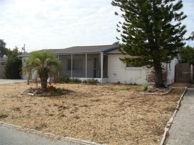 view of side of property featuring a sunroom