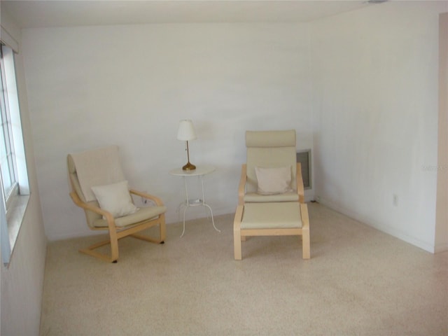 sitting room featuring light carpet