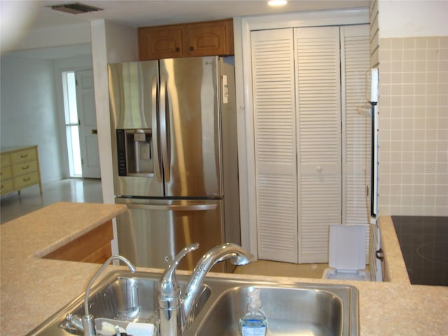 kitchen featuring stainless steel fridge and sink