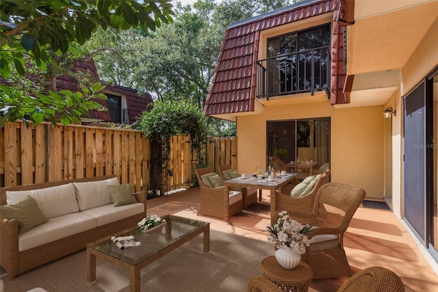 view of patio / terrace with a balcony and an outdoor hangout area