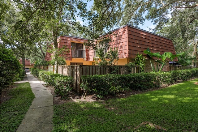 view of side of home featuring a yard