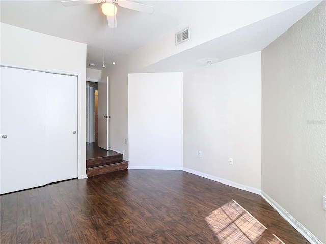 spare room featuring ceiling fan and dark hardwood / wood-style flooring