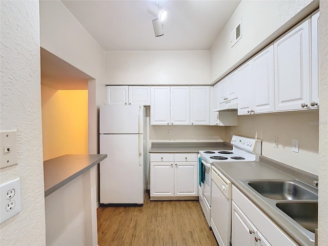 kitchen with white cabinets, light hardwood / wood-style flooring, sink, and white appliances