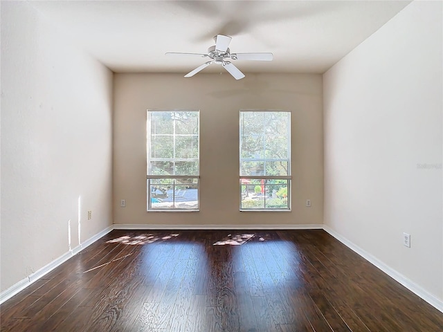 empty room with ceiling fan and dark hardwood / wood-style floors