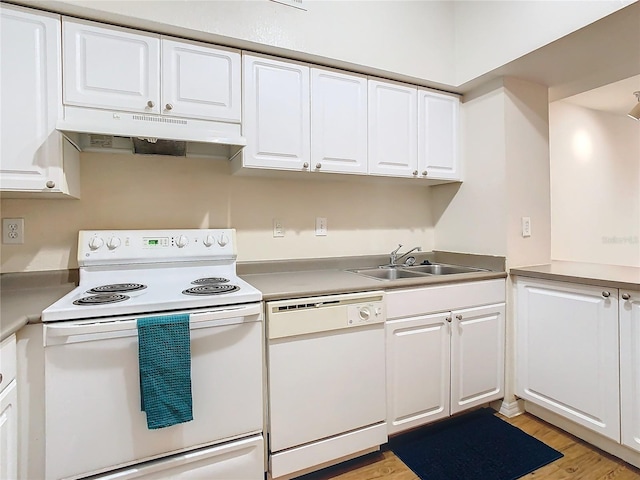 kitchen with white appliances, sink, and white cabinets