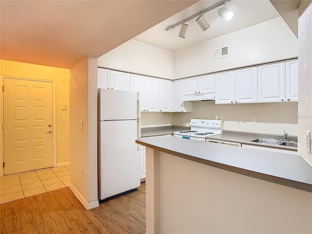 kitchen featuring white appliances, sink, and white cabinets