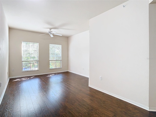 empty room featuring ceiling fan and dark wood-type flooring