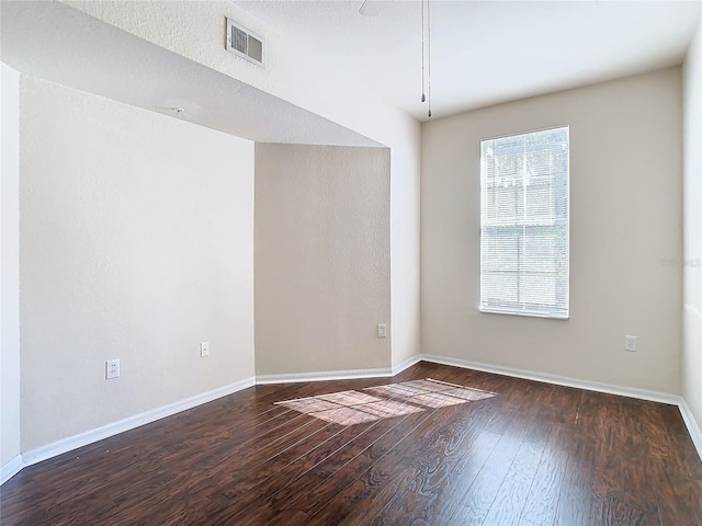 unfurnished room with dark hardwood / wood-style flooring