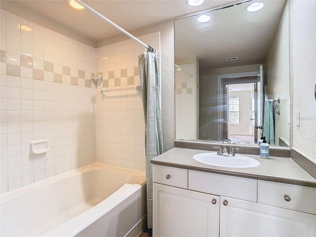 bathroom featuring vanity and shower / bath combination with curtain