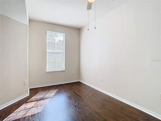 unfurnished room with dark wood-type flooring and ceiling fan