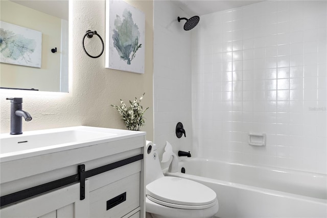 full bathroom with tiled shower / bath, vanity, and toilet