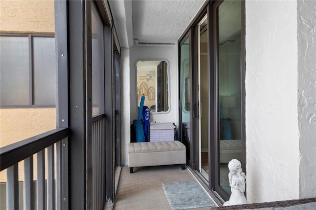 hallway with a textured ceiling