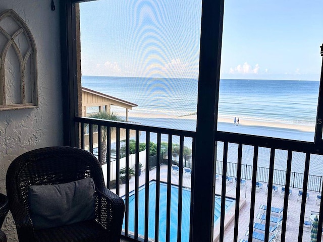 balcony with a beach view and a water view