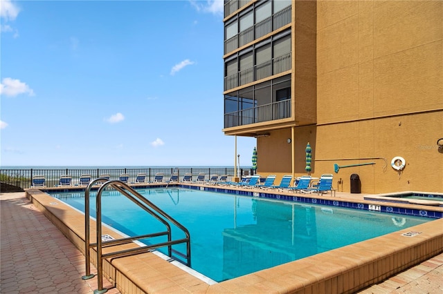 view of pool with a jacuzzi