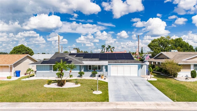 single story home with a garage, solar panels, and a front lawn