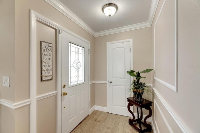 entrance foyer with light wood-type flooring and ornamental molding