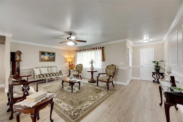 living room featuring a textured ceiling, crown molding, light hardwood / wood-style floors, and ceiling fan