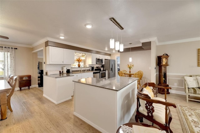 kitchen with a center island, white cabinets, light hardwood / wood-style flooring, stainless steel appliances, and decorative light fixtures