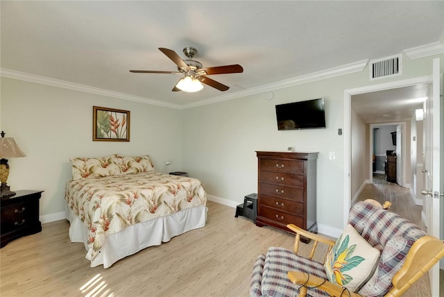 bedroom with crown molding, light hardwood / wood-style floors, and ceiling fan