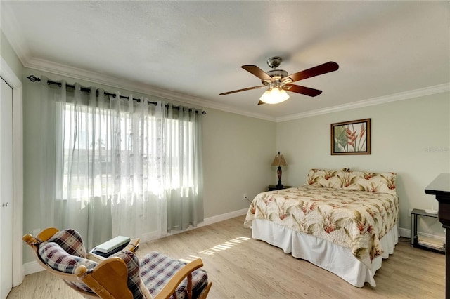 bedroom with light hardwood / wood-style flooring, ceiling fan, and ornamental molding