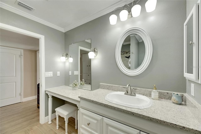 bathroom featuring ornamental molding, vanity, and wood-type flooring