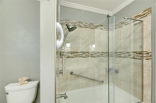 bathroom featuring crown molding, a shower with door, and toilet