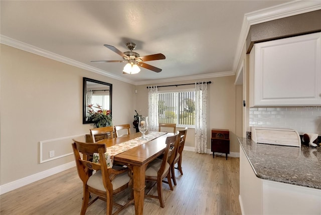 dining space with ceiling fan, ornamental molding, and light hardwood / wood-style floors