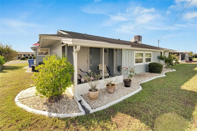 rear view of house featuring a lawn