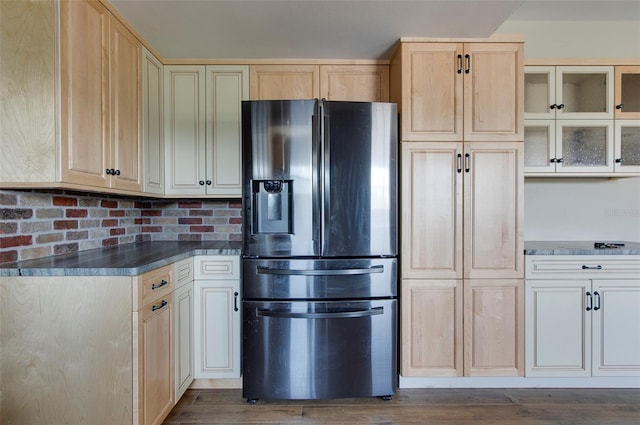 kitchen featuring backsplash, light brown cabinetry, dark hardwood / wood-style floors, and stainless steel fridge