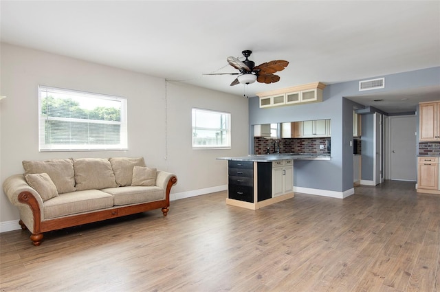 living room with light hardwood / wood-style flooring and ceiling fan