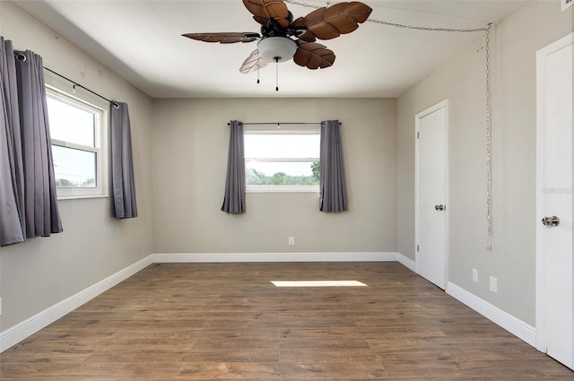 unfurnished room featuring ceiling fan, plenty of natural light, and hardwood / wood-style floors