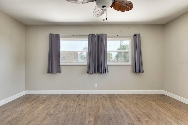 empty room featuring wood-type flooring and ceiling fan