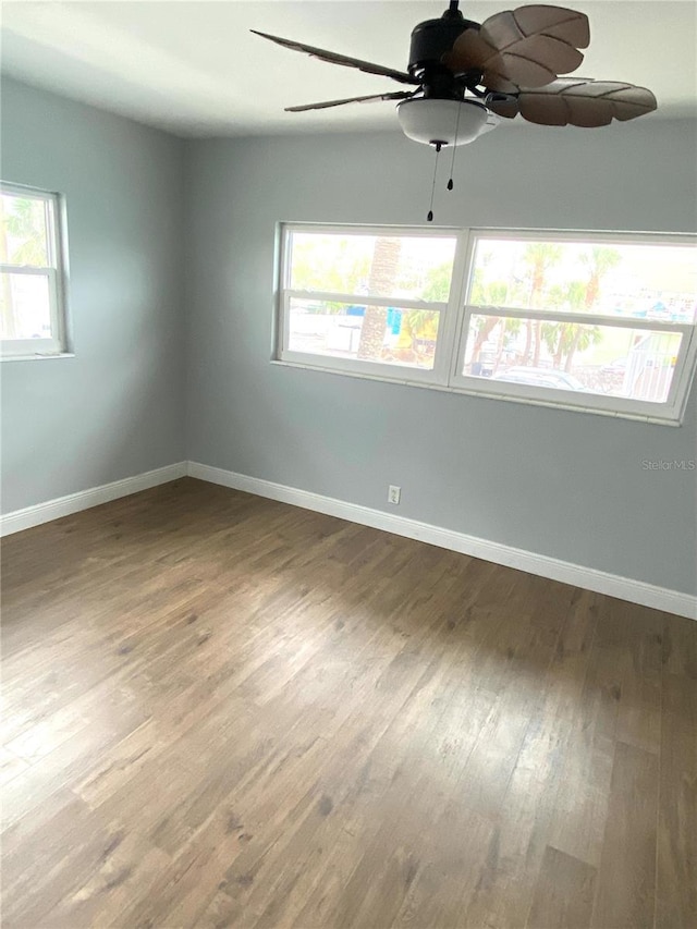 6000 2nd St E Unit 6, St Pete Beach, FL 33706 - unfurnished room featuring ceiling fan, wood finished floors, and baseboards