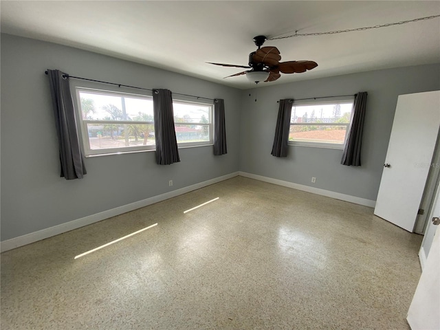 6000 2nd St E Unit 6, St Pete Beach, FL 33706 - spare room featuring a ceiling fan and baseboards