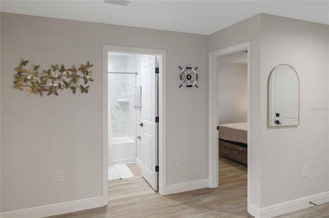 hallway with light hardwood / wood-style flooring