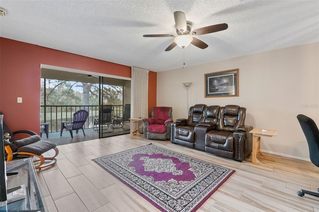 living room featuring a textured ceiling, light hardwood / wood-style floors, and ceiling fan