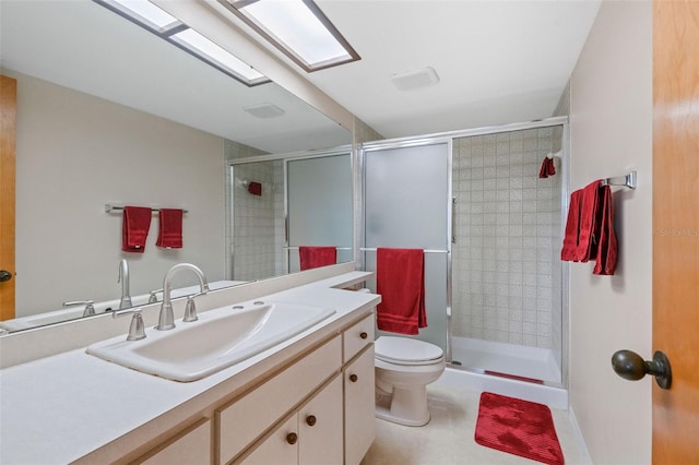 bathroom with a shower with shower door, vanity, and toilet