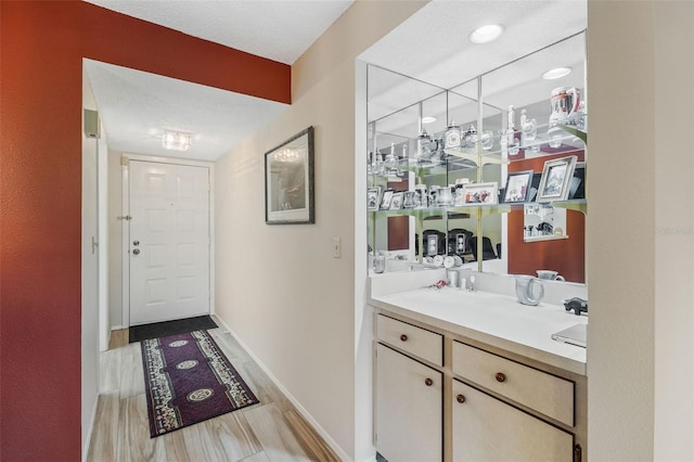 bathroom featuring vanity, a textured ceiling, and hardwood / wood-style flooring