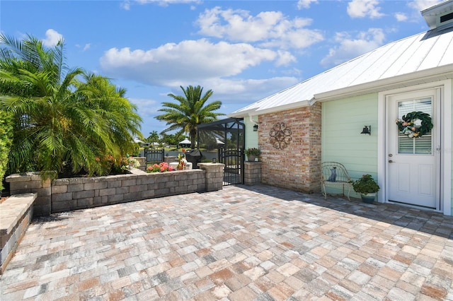 view of patio / terrace featuring glass enclosure