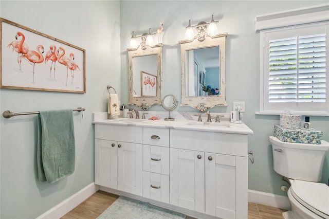 bathroom featuring vanity, toilet, and hardwood / wood-style flooring