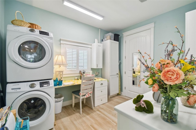 washroom featuring light hardwood / wood-style flooring and stacked washing maching and dryer