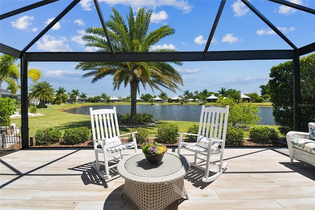 view of patio featuring glass enclosure and a water view