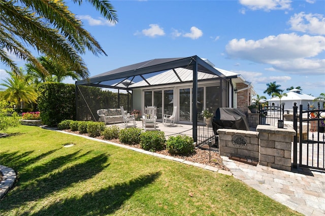 exterior space featuring a patio, a yard, and glass enclosure