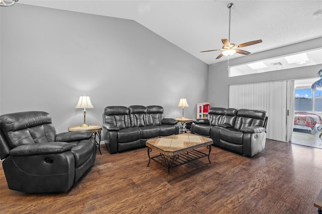 living room with lofted ceiling, ceiling fan, and dark wood-type flooring