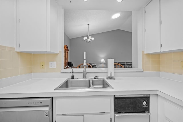 kitchen with vaulted ceiling, white cabinets, dishwasher, decorative light fixtures, and a notable chandelier