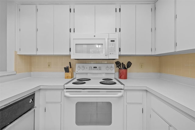 kitchen with white cabinets, tasteful backsplash, and white appliances