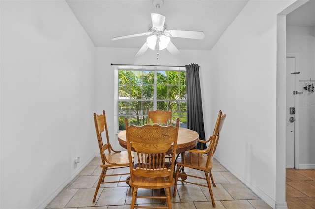 tiled dining area with ceiling fan