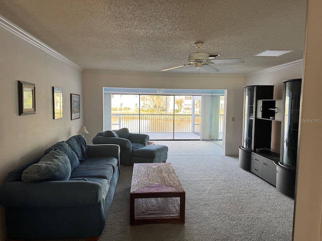 living room featuring ornamental molding, a textured ceiling, carpet floors, and ceiling fan