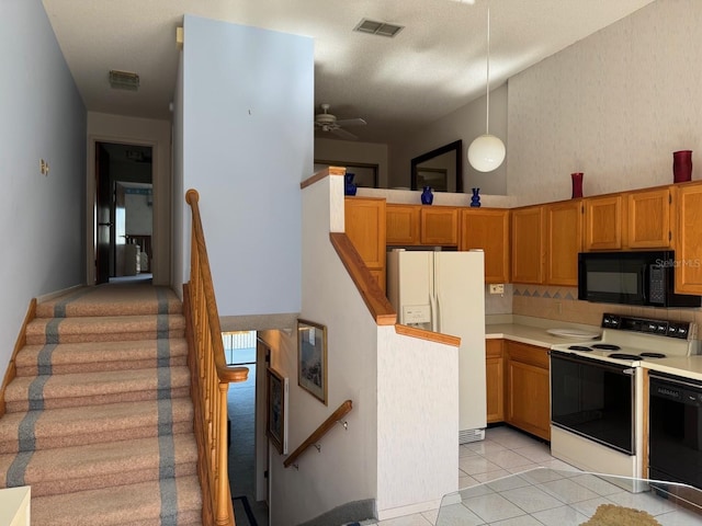 1873 Mazo Mnr Unit T2, Lutz, FL 33558 - kitchen with black appliances, light countertops, pendant lighting, light tile patterned flooring, and ceiling fan