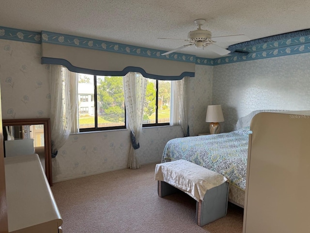 1873 Mazo Mnr Unit T2, Lutz, FL 33558 - carpeted bedroom with wallpapered walls, a textured ceiling, and a ceiling fan